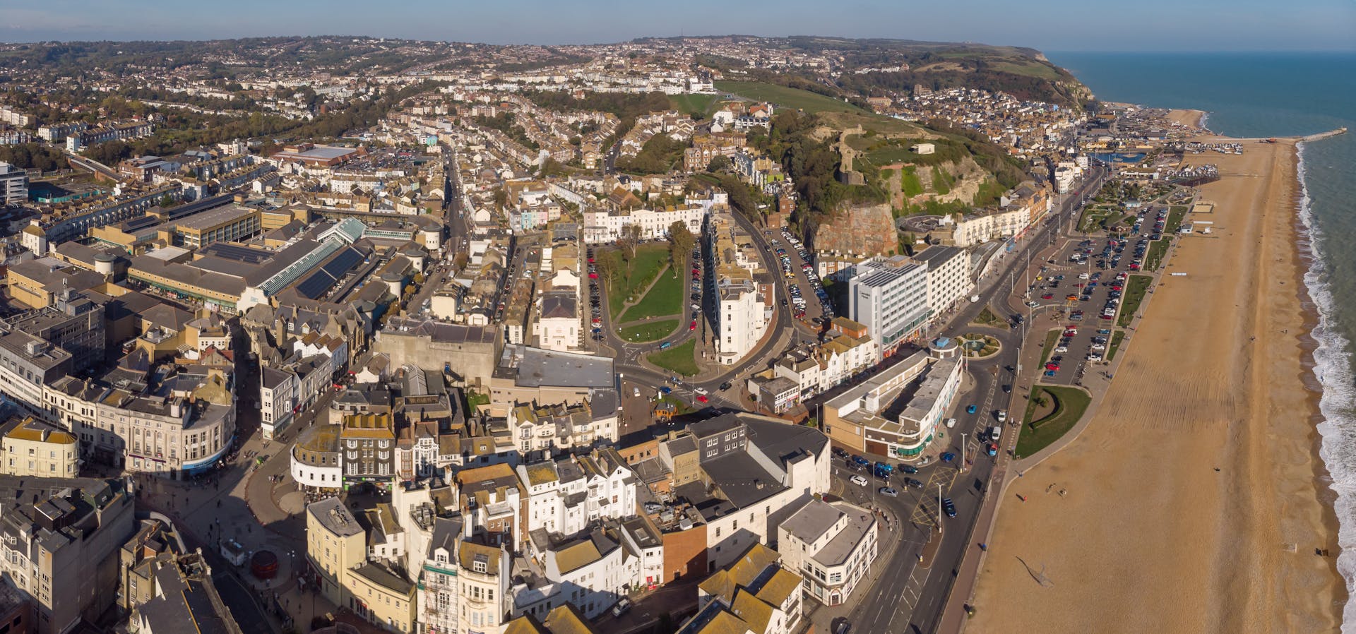 Aerial view of a vibrant coastal town in England with beach and cityscape.
