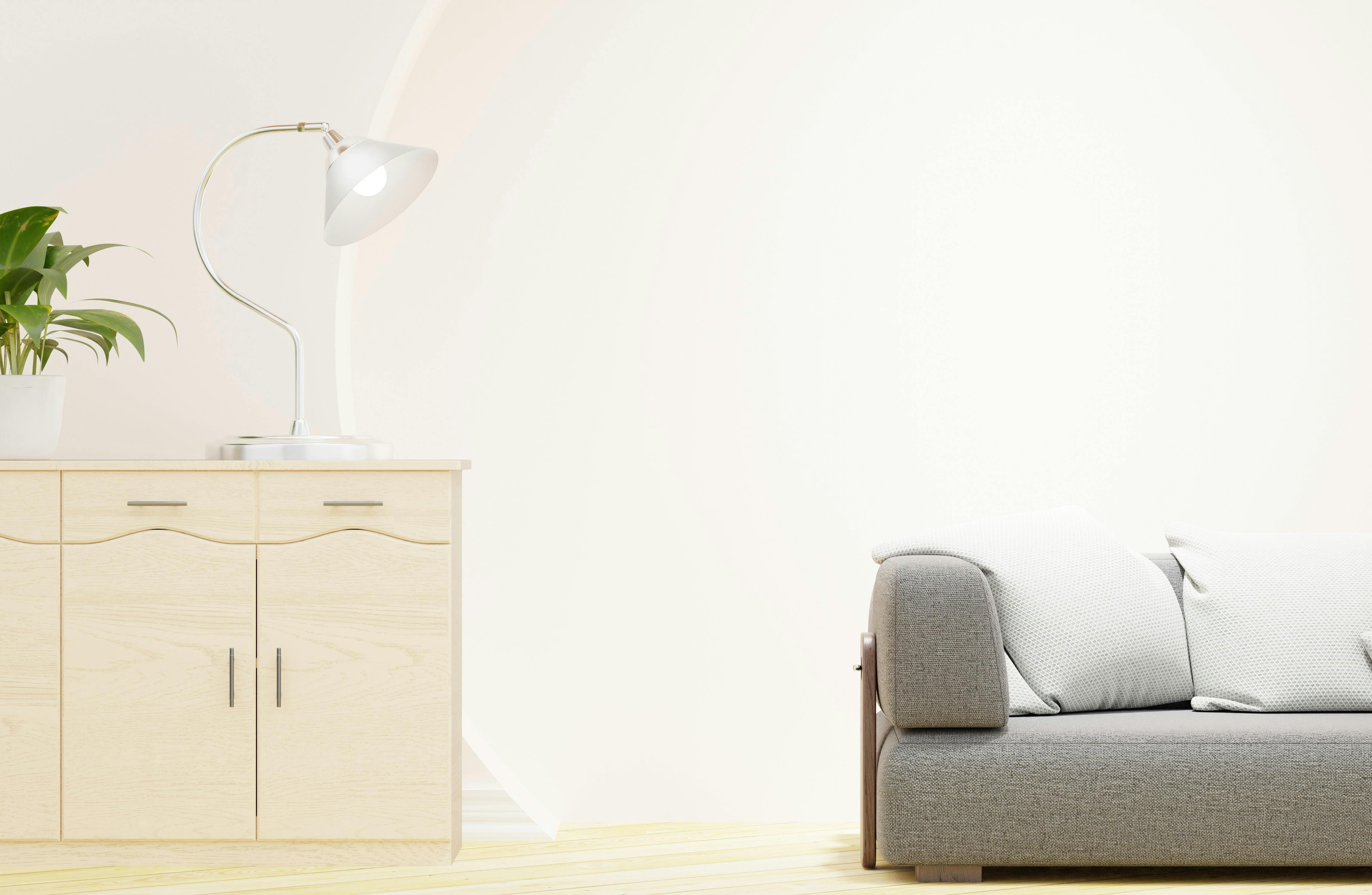 Sofa shown with light green cushions and decor in a minimalist living room