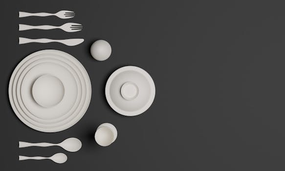 Top view of elegant white tableware with spoons and forks on a dark surface.