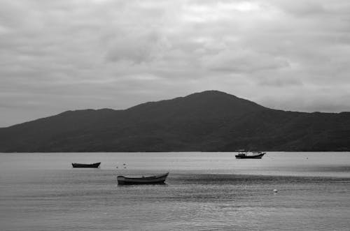 Grayscale Photo of Boats on Sea