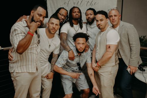 Free A diverse group of men gathered indoors, posing at a special event. Celebratory scene. Stock Photo