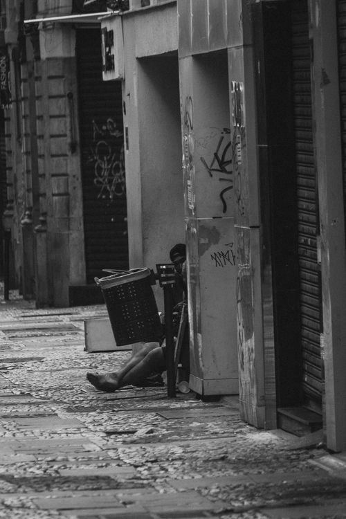 Free Monochrome city street with graffiti and closed shops, conveying urban solitude. Stock Photo