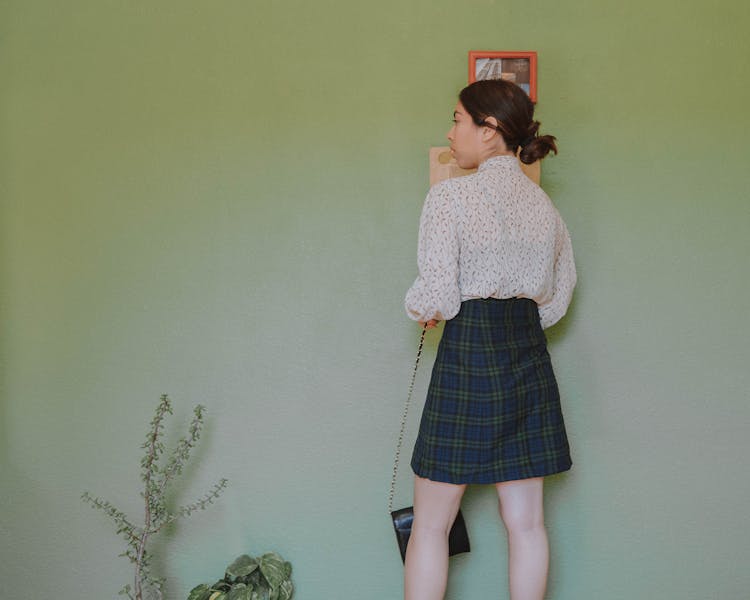 Young Woman In A Plaid Skirt And Shirt 