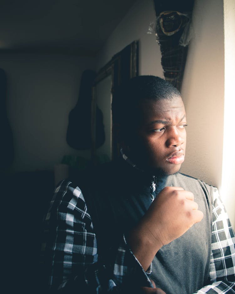 Young Man Standing By The Window 