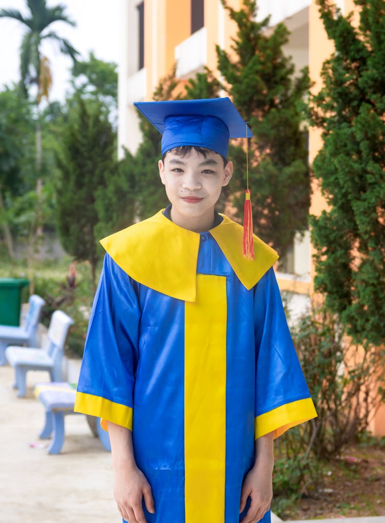 Young Boy In A Graduation Gown 