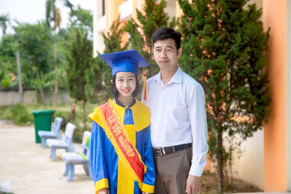 A parent waving goodbye to a teenager in a school parking lot at drop-off time. Captured by Thành Đỗ