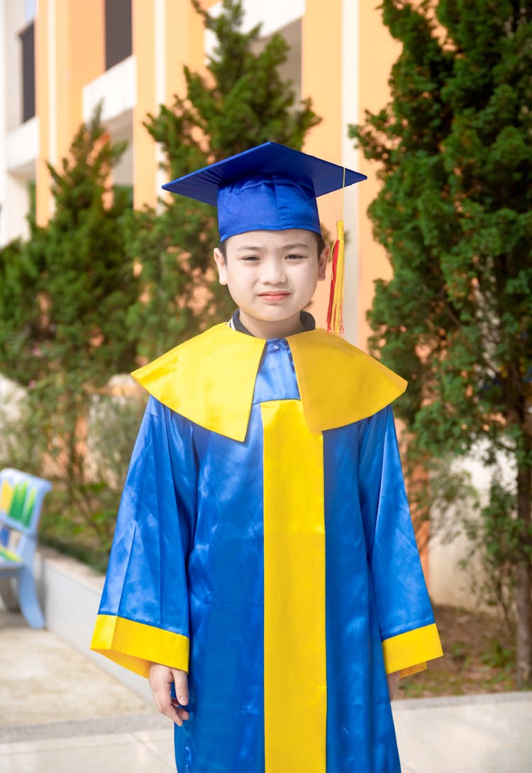 A Graduating Student Smiling At The Camera