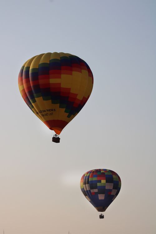 Free Vibrant hot air balloons floating above Tequisquiapan, Mexico under a clear blue sky. Stock Photo