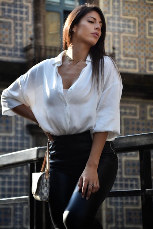 A Woman in White Top and Black Pants