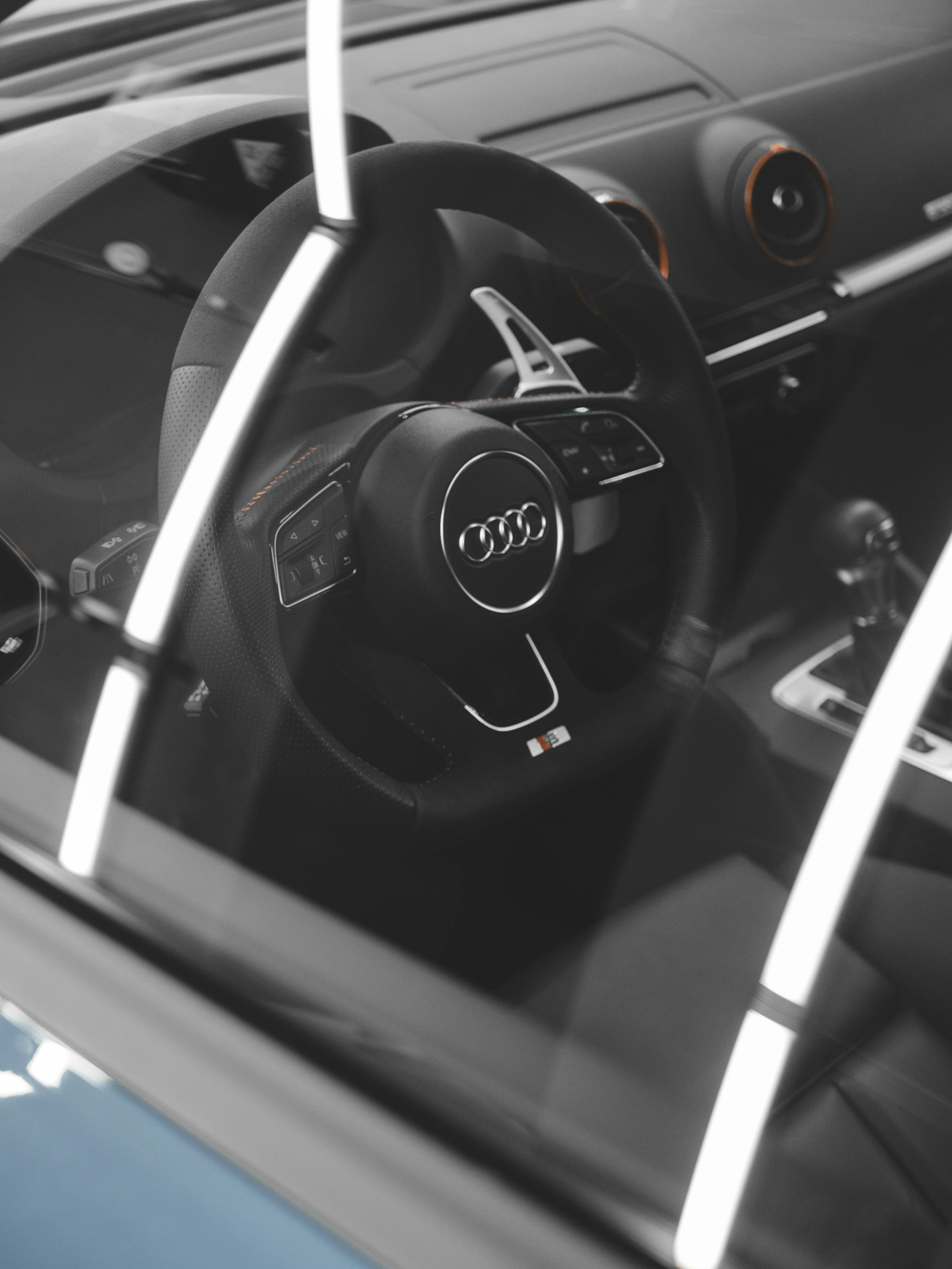 Free Luxury Audi car interior showcasing the elegant steering wheel and design details. Stock Photo