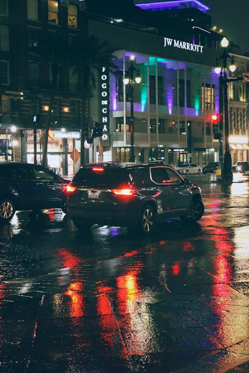 Cars on a Wet Road during Night Time