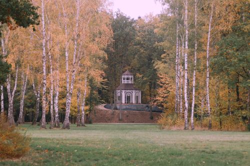 Free Charming autumn landscape with a rustic gazebo surrounded by colorful foliage in Zatonie, Poland. Stock Photo