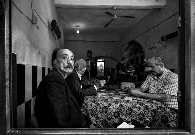 Men Playing Cards In A Restaurant 