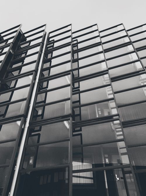 Free Low-angle shot of a modern glass building facade in Alkmaar, Netherlands. Stock Photo