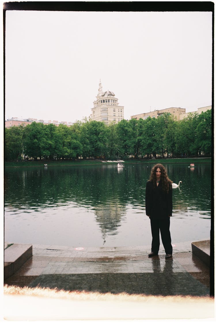 Woman In Suit By River In City