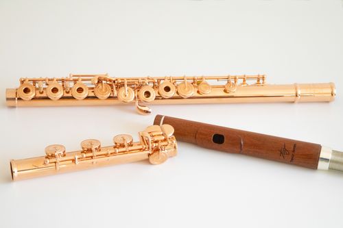 Free Close-up of elegant copper flutes and a woodwind instrument on a white background. Stock Photo