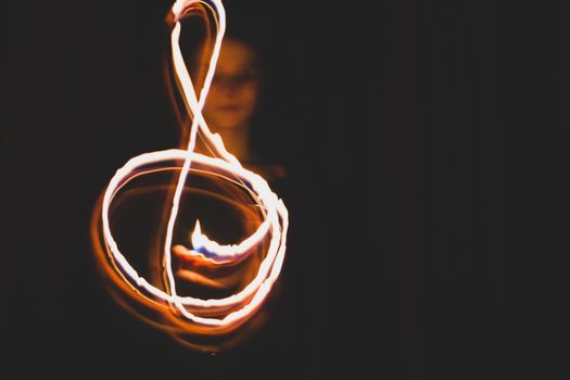 Woman Making a Shape with a Flame on a Fireshow 