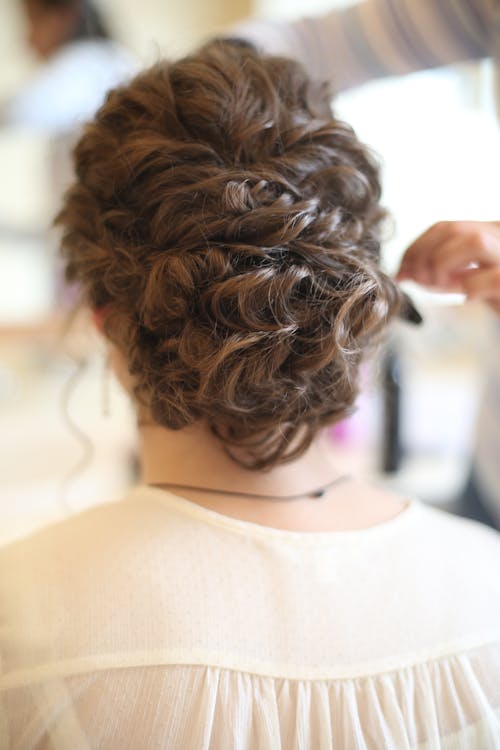 Free Person in Beige Blouse Sitting in Beautiful Hairstyle Stock Photo