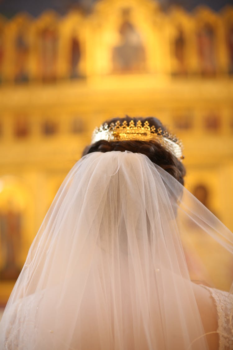 Back View Of Man Wearing Crown And Veil In Church