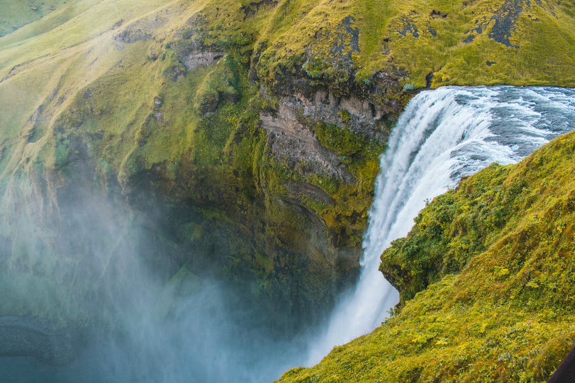 Bird's Eye View Photography of Water Falls Rushing Through Cliff