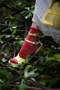 Close-up of a Woman Foot in High Heels Stepping Through Forest Ground 