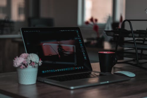 Free Macbook on Table Beside Mug in Shallow Focus Photography Stock Photo