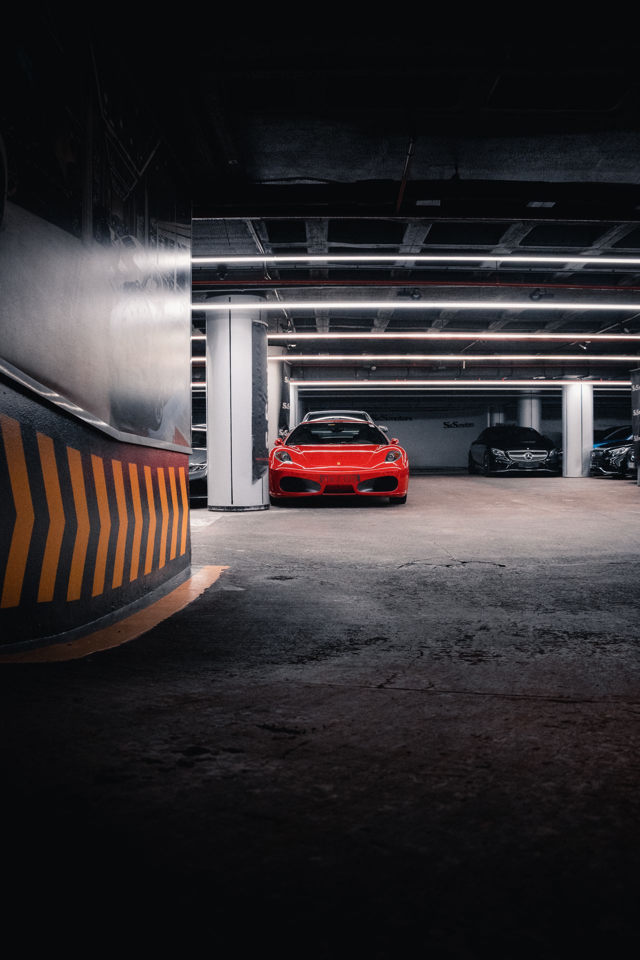 modern-garage-decor-hero Red sports car parked in a modern garage with LED strip lighting and a polished floor