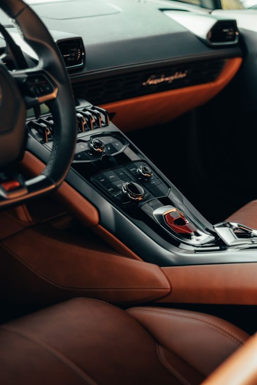 Free Explore the luxurious design of this car interior featuring elegant leather and modern controls. Stock Photo
