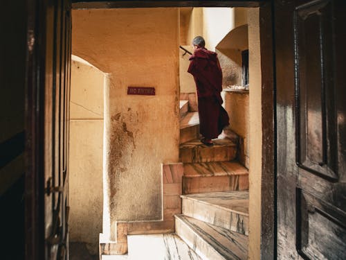 A Man Walking while Going Up Stairs