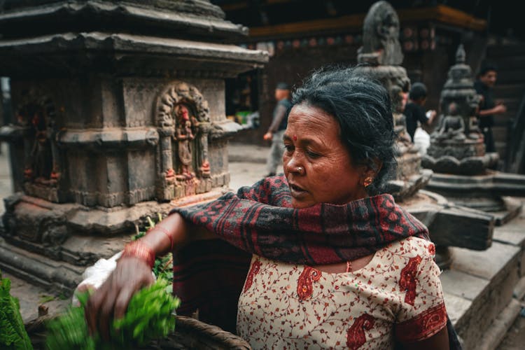 Woman In Traditional Clothes Near Old Temple