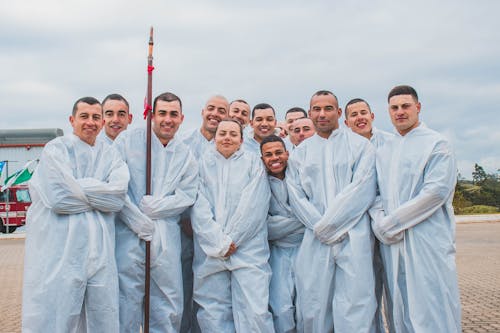 Free Group of Men in White Robe Posing for Photo Stock Photo