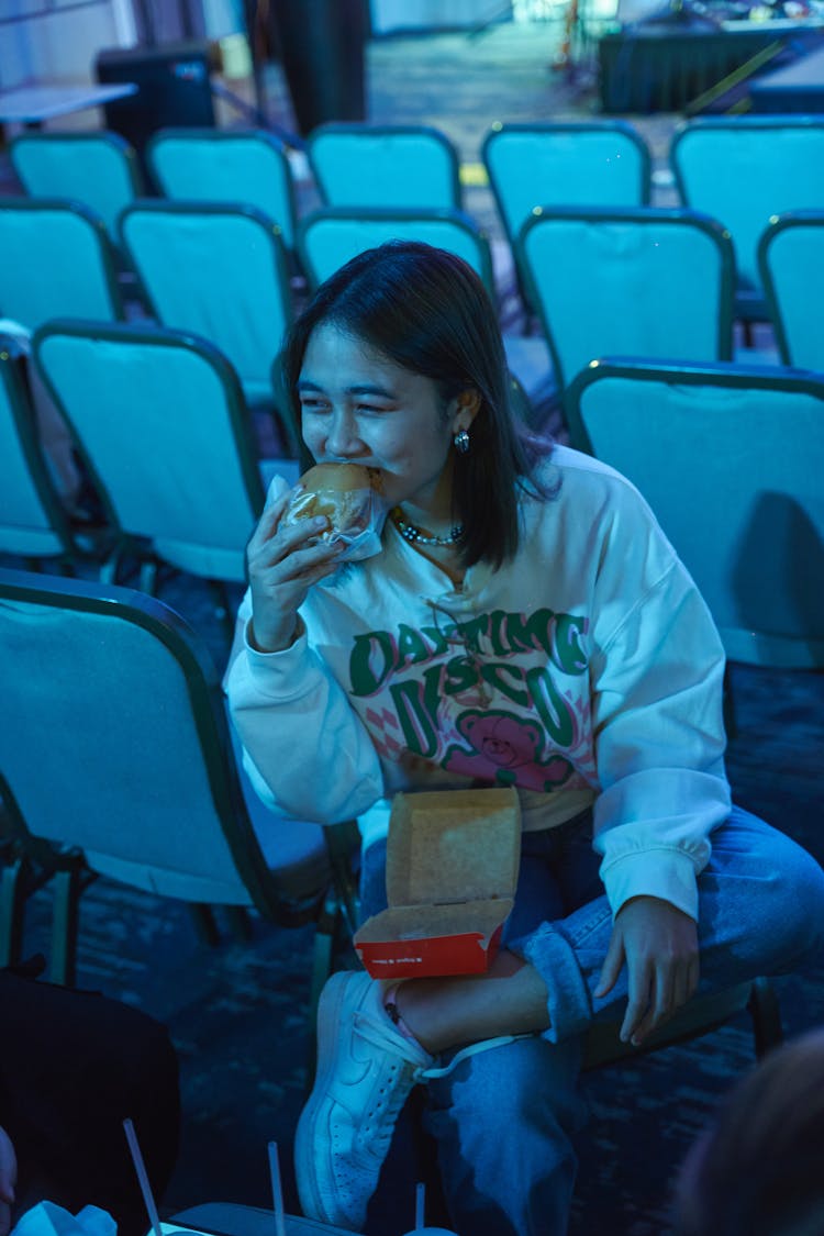 Young Woman Eating A Burger 