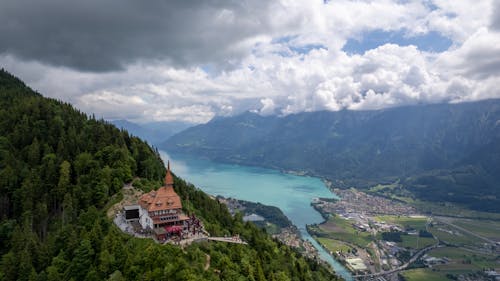 Aerial View of Brown Concrete Building Surrounded by Trees on the Mountain