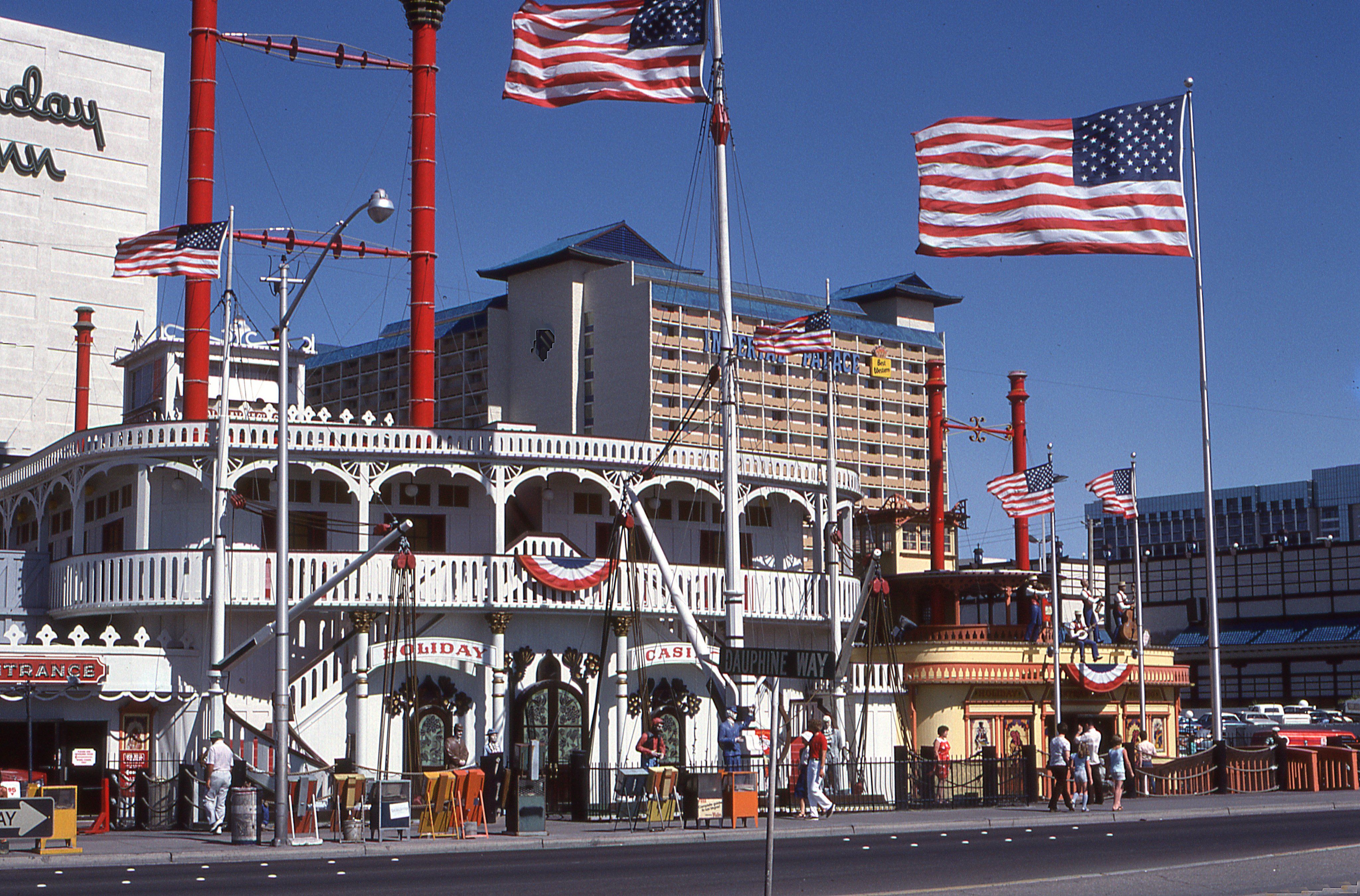 View of American flags and festive street scene in downtown Las Vegas.