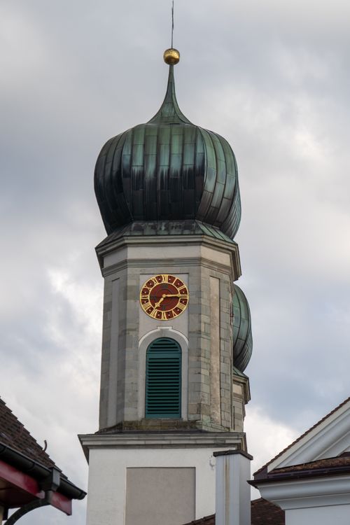 Free A stunning church tower with a distinctive dome in Lachen, Switzerland set against a cloudy sky. Stock Photo