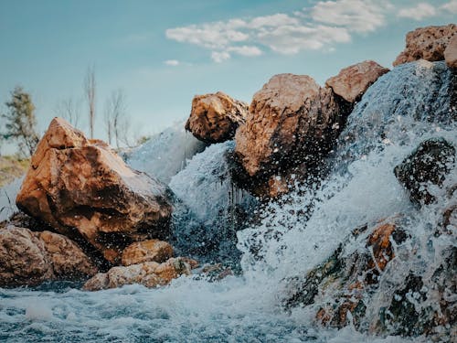 Brown Rock Formation on Body of Water