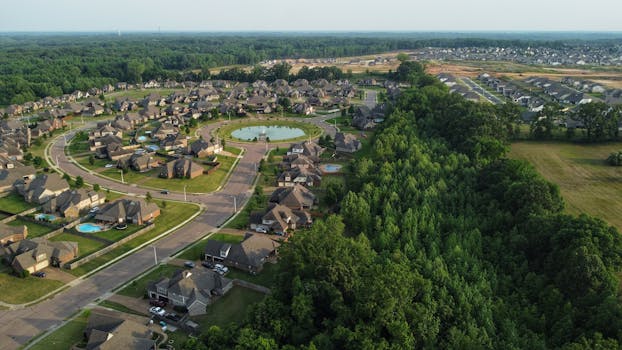Aerial view showcasing a suburban neighborhood in Memphis, TN with houses and trees.