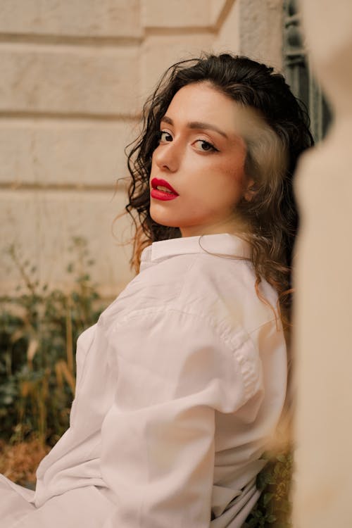 A Woman in White Long Sleeves with Red Lipstick