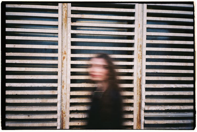 An Old Photograph Of A Woman In Double Exposure