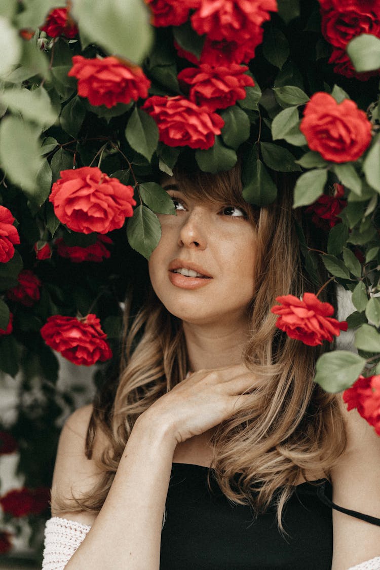 Blonde Woman Standing Under Rose Bush