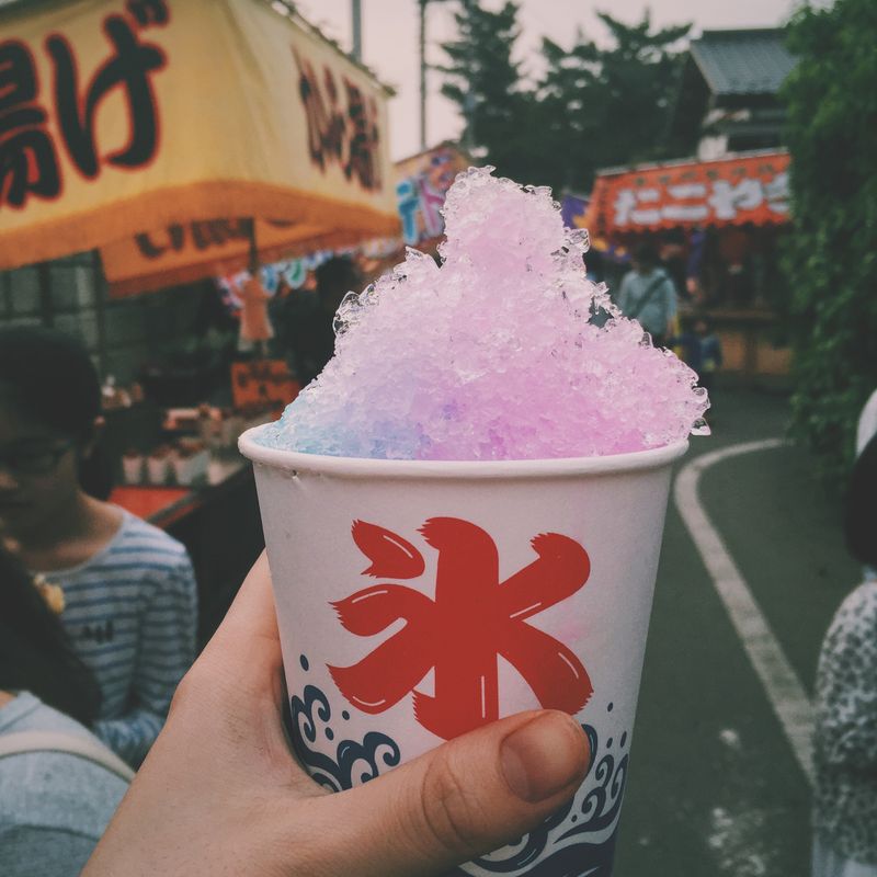 Vibrant shaved ice dessert at a Japanese street festival