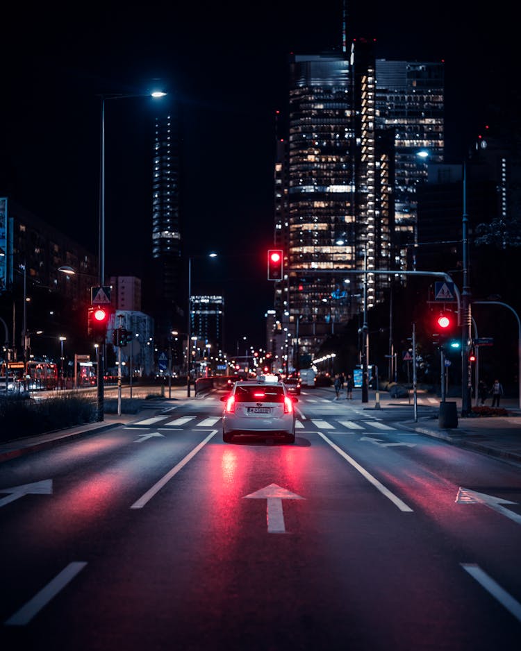 A Car Stopping On The Road Near Stop Light