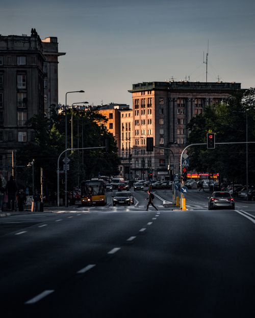 Free Moody Warsaw street scene at twilight, capturing urban life and architecture. Stock Photo