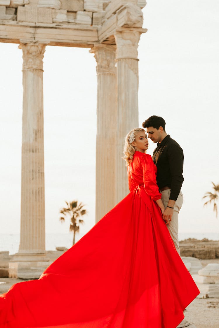 Couple Standing Near Concrete Pillars