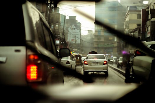 Busy street scene with cars in the rain, capturing urban life and traffic.