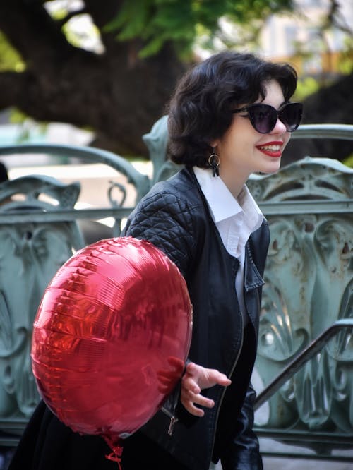 Woman Holding a Red Balloon