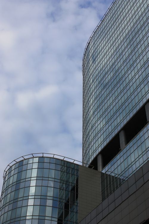 Free A striking view of modern glass skyscrapers with a cloudy sky backdrop, showcasing urban architecture. Stock Photo