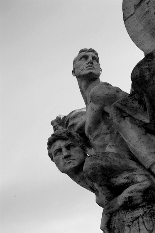 A Grayscale of Sculptures of Men