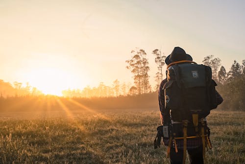 Free Man in Black Backpack during Golden Hour Stock Photo
