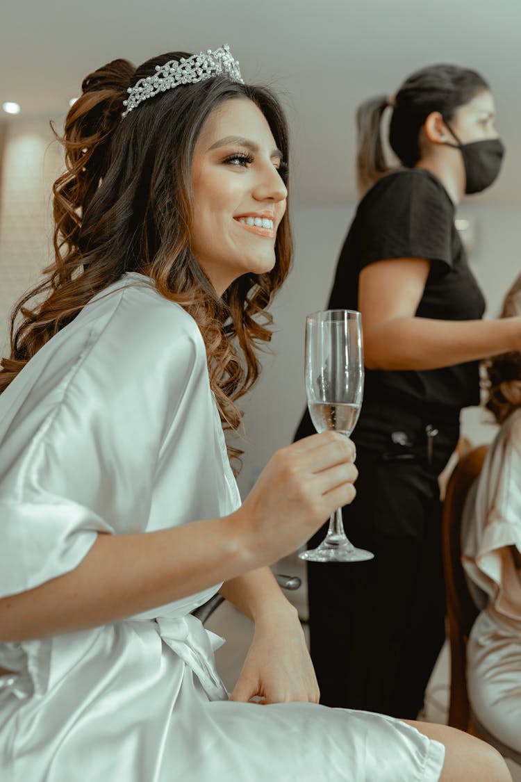 Women In Mask And With Champagne